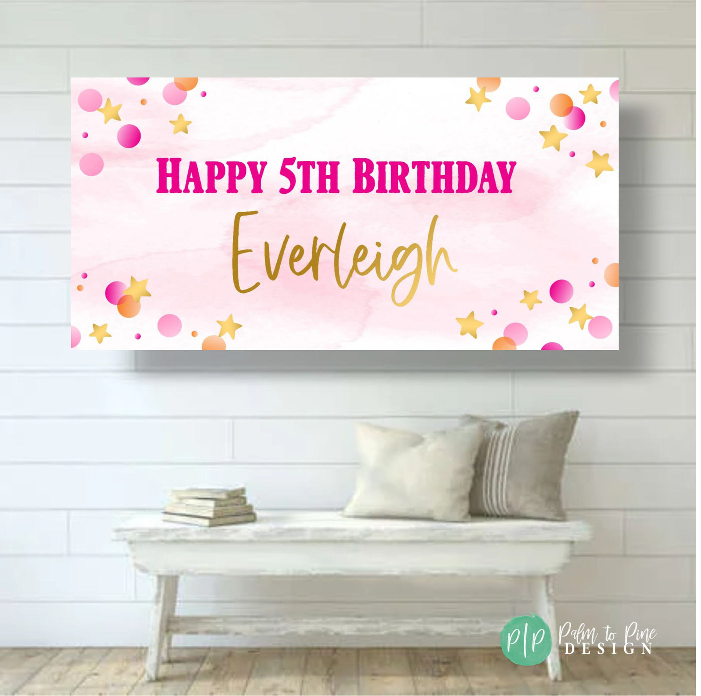 Festive birthday party banner in pink and gold with a bright Happy Birthday wording hanging on the wall