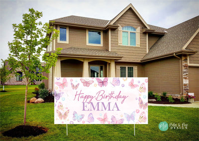 Soft pink and purple birthday banner with butterfly designs in yard