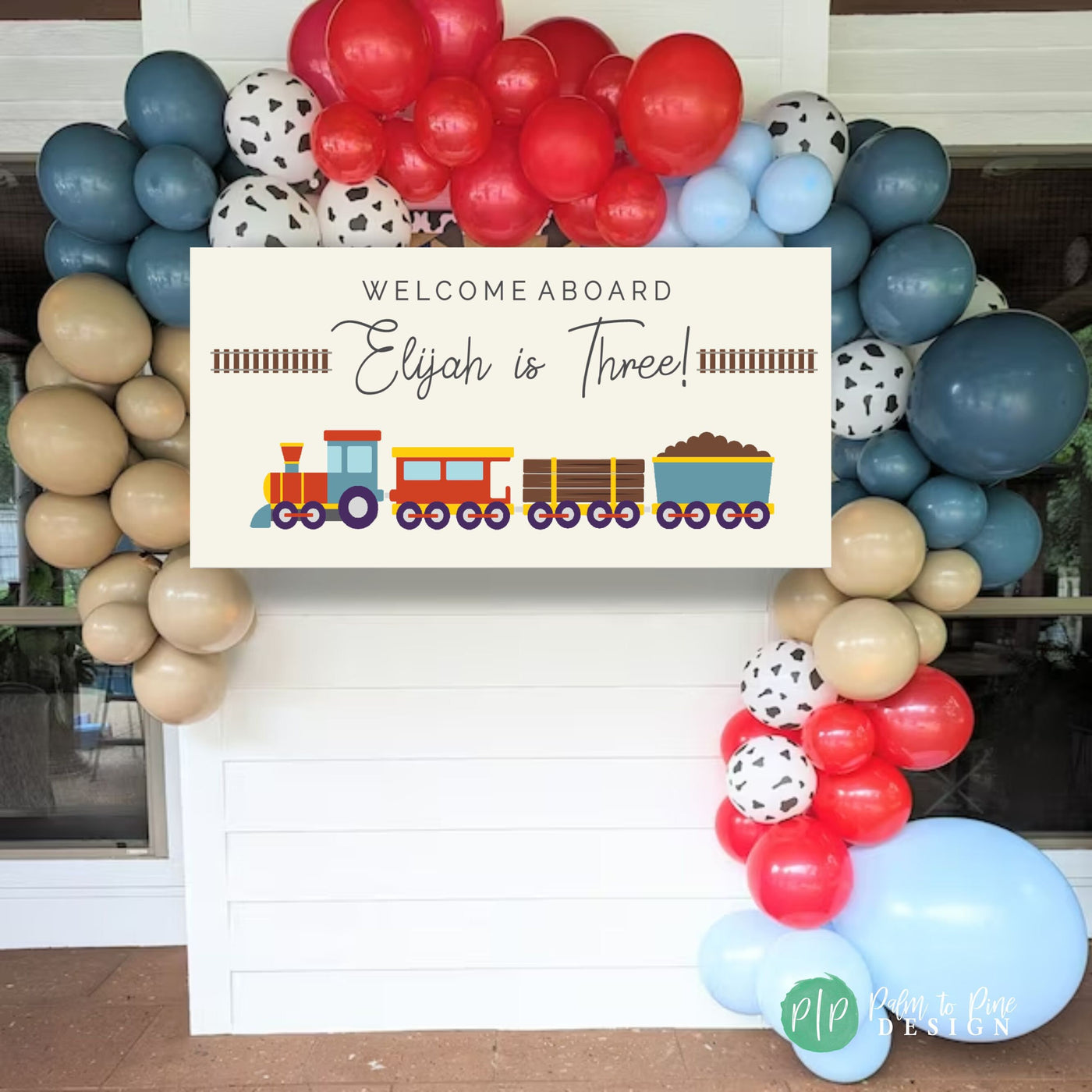 A modern and minimalist train-themed birthday banner on a soft tan backdrop, highlighted by colorful train clipart in red, yellow, and blue, with simple railroad track accents with a balloon garland