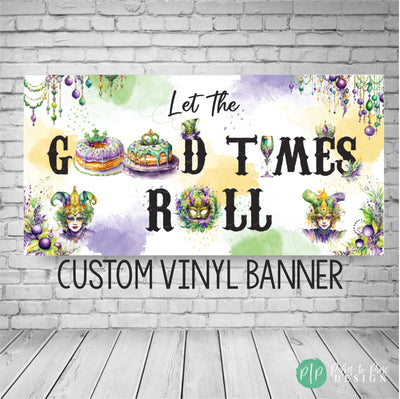 Mardi Gras banner with the phrase &#39;Let the Good Times Roll&#39; Designed in traditional Mardi Gras colors: purple, green, and gold. The banner is decorated with vibrant accents like beads, masks, and fleur-de-lis symbols