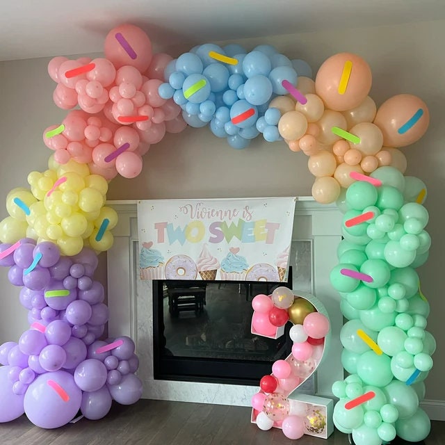 Two sweet Birthday Banner and pastel balloon arch with sprinkles