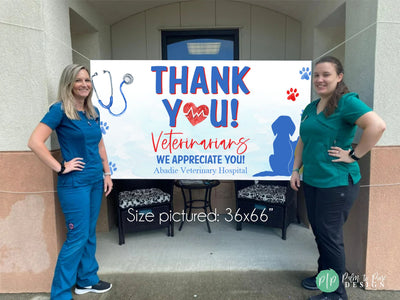 Veterinarians standing in front of Veterinary Appreciation Day banner