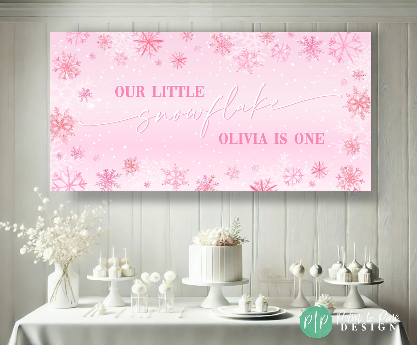 snowy white winter onederland birthday dessert table with custom pink snowflake banner