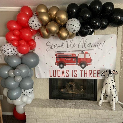 firefighter birthday banner with balloon garland and dalmatian