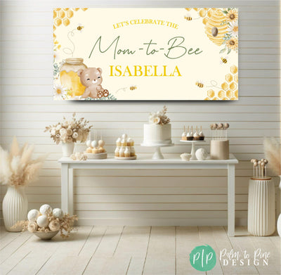 mom-to-bee baby shower banner in front of neutral dessert table with baby shower theme