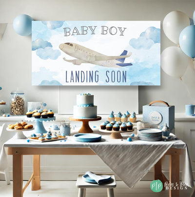 Plane themed boys baby shower with personalized airplane banner reading baby boy landing soon and blue and white desserts