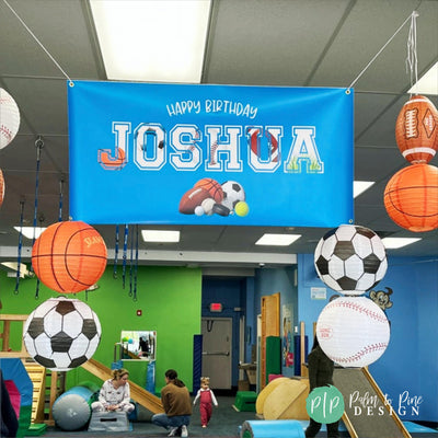 Personalized sports birthday banner with modern graphics of basketballs, soccer balls, footballs, and baseballs at kids birthdayparty