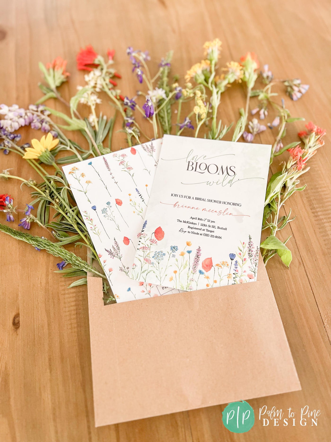 Simple and elegant wildflower party invitations with kraft envelope and wildflower blooms coming out of envelope