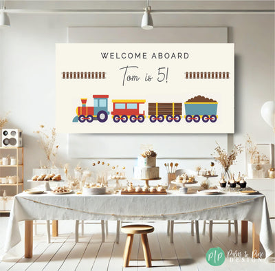 A modern and minimalist train-themed birthday banner and neutral boho dessert table