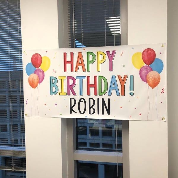 Close-up of a personalized birthday banner with vibrant rainbow letters and customizable name option, ideal for any celebration