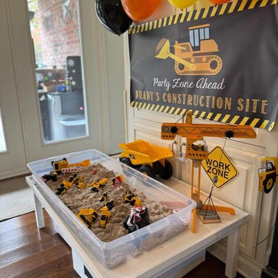 Boys construction birthday party theme with sandbox, crane and personalized construction banner