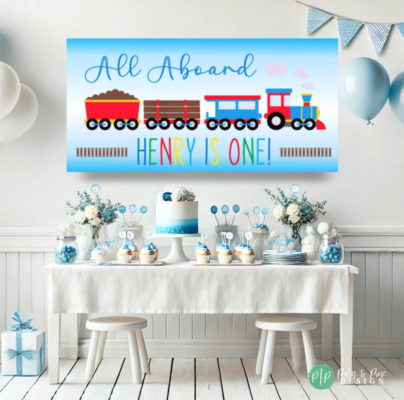 kids train birthday party with personalized banner and blue dessert table